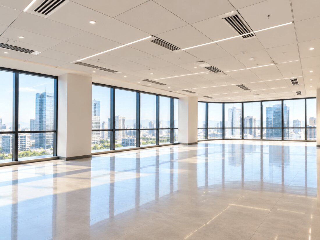 Unfurnished bare shell office floor in Pune with polished flooring, false ceiling and full-height city-view glazing